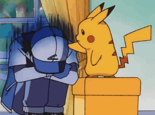 animated gif of Pikachu standing on a box comforting Ash, patting him on the head